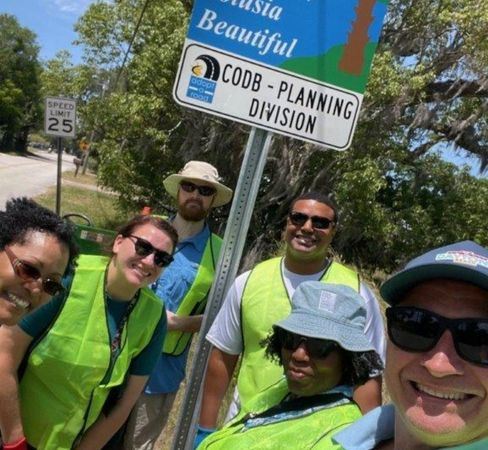 Photo showing the planning team participating in a team building community service clean up